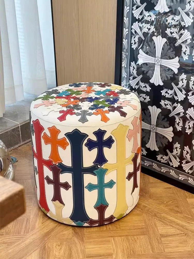 chrome cross ottomon stool on wooden floor.